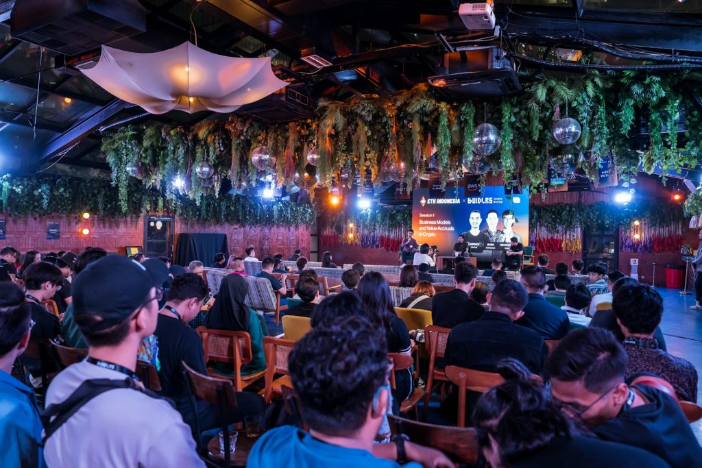 A large group of people sitting in a room